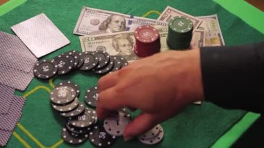 Riskli bir poker oyuncusunun elleri yavaş yavaş beyaz çipleri yakına topluyor..