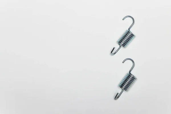 Zwei kurze Metallfedern zur Reparatur der Bremsen der Maschine. — Stockfoto