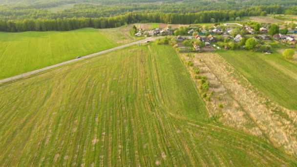 Beautiful agricultural plantations, fields, village and road, aerial view. — Stock Video