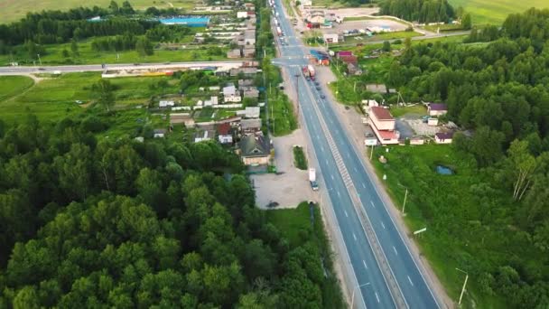 Вид с воздуха на асфальтовое пригородное пересечение с ожидающими автомобилями. — стоковое видео