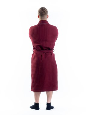 Arkadan bornozlu bir adam izole edilmiş beyaz bir arka planda. Stüdyoda tam gelişimle çekilmiştir..