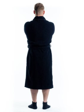 Arkadan bornozlu bir adam izole edilmiş beyaz bir arka planda. Stüdyoda tam gelişimle çekilmiştir..