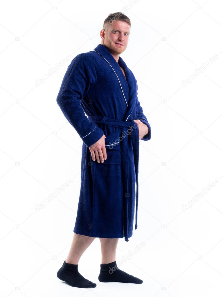 strong man in a Bathrobe on an isolated white background with a smile on his face. Shot in the Studio in full growth.