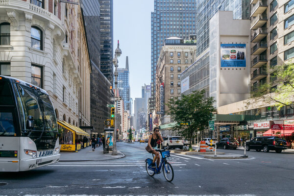 New York, USA - September 20, 2015: Girl rides a bike on the street of Manhattan.