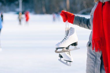 Young woman showing ice skates for winter