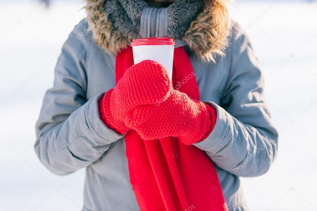 Woman holding winter cup close up