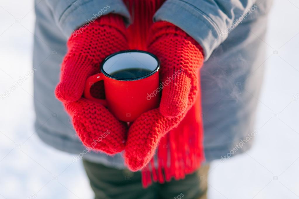 Woman holding winter cup close up
