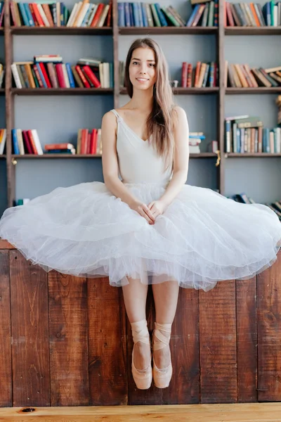 Молодая балерина, стоящая на поите в баре в балетном классе — стоковое фото