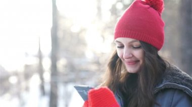 mutlu genç kadın kış Park'ta SMS yazma