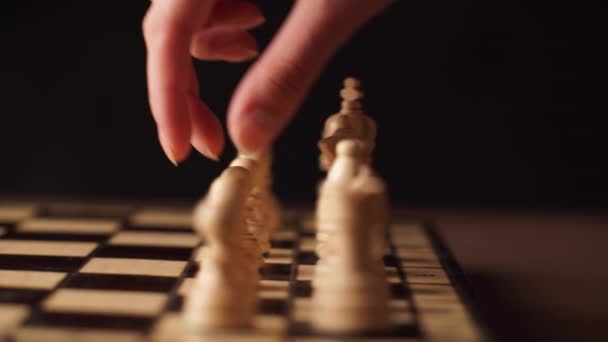 Man playing wooden chess pieces — Stock Video