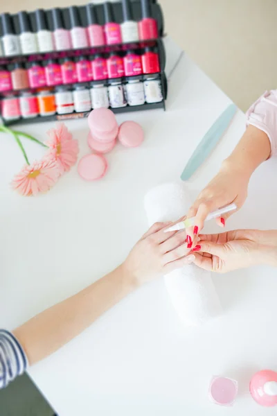 Mujer en salón recibiendo manicura por uña esteticista — Foto de Stock