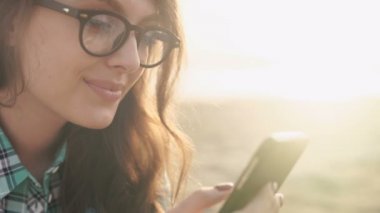 şık genç kadın, bir telefon, kot gömlek ve pantolon holding eller güzel.