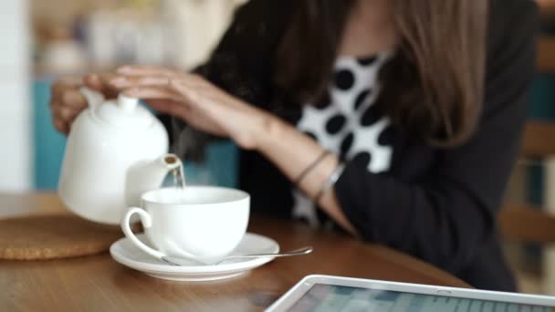 Woman pouring milk in mug from kettle — Stock Video