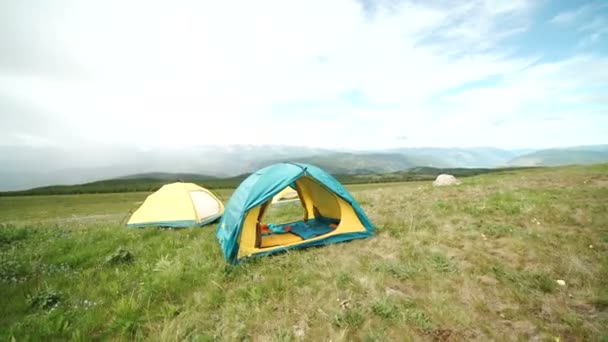 Tourist tent in camp among meadow in the mountain — Stock Video