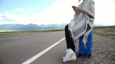 bavul bir çöl Road üzerinde oturan güzel kadın