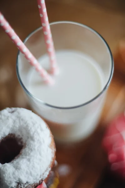 Pink, yellow, white donuts and milk — Stock Photo, Image