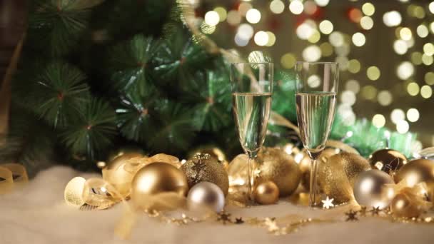 Two glasses of champagne with christmas present and christmas balls — Stock Video