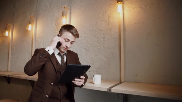 英俊的男人在咖啡馆使用智能手机和微笑 — 图库视频影像