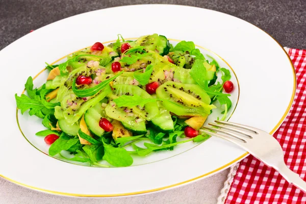 Alimento saludable y dietético: Ensalada con rúcula, aguacate, kiwi, pepino —  Fotos de Stock