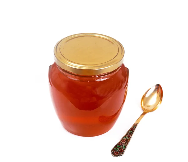 Frasco com mel isolado sobre fundo branco. — Fotografia de Stock