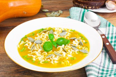 Pumpkin Soup with Pasta and Basil. Diet Food clipart