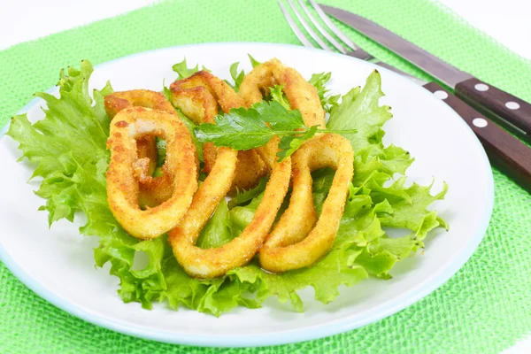Fried Squid Rings in Breadcrumbs with Lettuce and Lemon