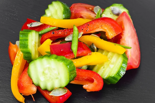 Healthy and diet food: Lettuce, tomato, pepper, seeds, oil, salt