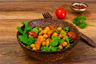 Nohut bir köri sosu, roka, kızarmış kabak salatası