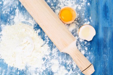 Un, yumurta ve oklava mavi bir arka plan üzerinde