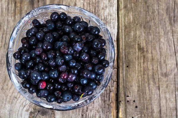 Bilberry in Crystal Bowl on Rustic Background