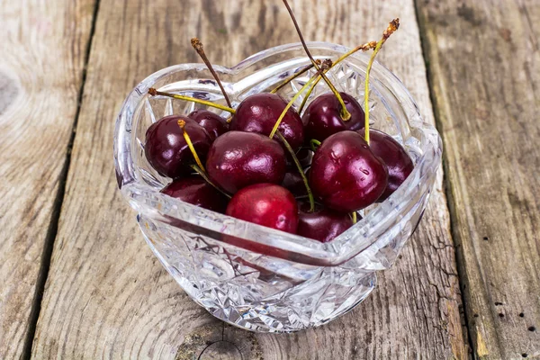 Cherries in Crystal Bowl on Rustic Background