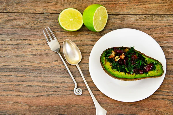 Avocado salad with herbs dill, parsley, cilantro, nuts and sun — Stock Photo, Image