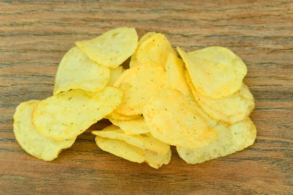 Potato Chips on Wood Background.
