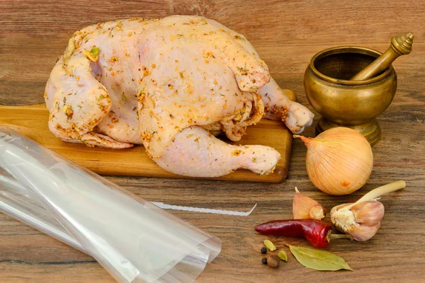 Raw Chicken with Herbs on Wood Background.