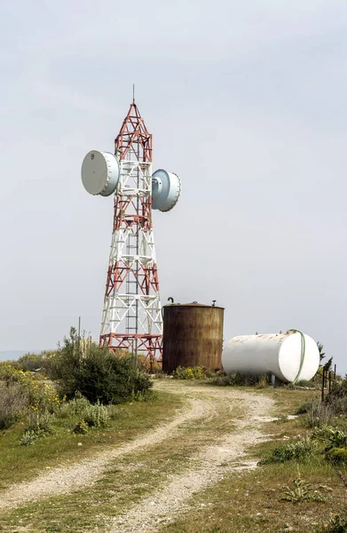 Telecommunication equipment and equipment for mobile communications against mountains and sky on a sunny, spring day