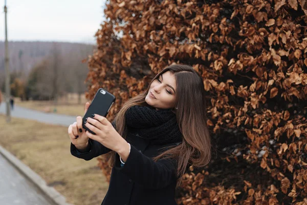 Hübsches Mädchen macht Selfie im Park — Stockfoto