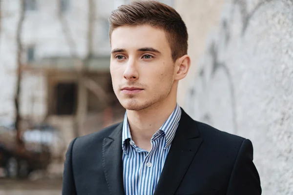 Portrait of serious good-looking man with blue eyes