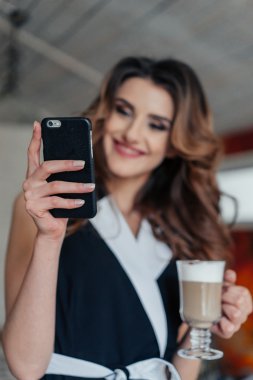 Kafede masada oturan ve gülümseyen stil Bayan