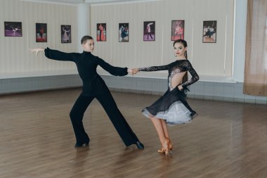 Professional dancers dancing in ballroom. Latin. clipart