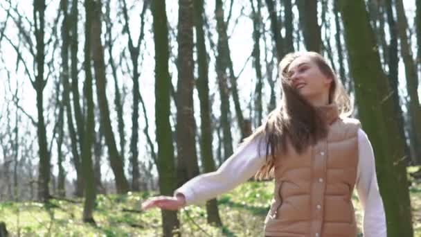 Mooi meisje springen in een zonnige lente-forest. Langzaam — Stockvideo