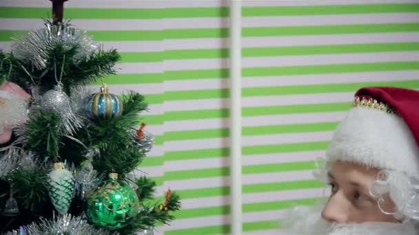 Санта Клаус рядом с деревом — стоковое видео