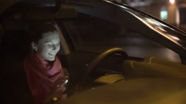 Mutlu kız akşam yağmur, arabada tablet kullanma. 4k