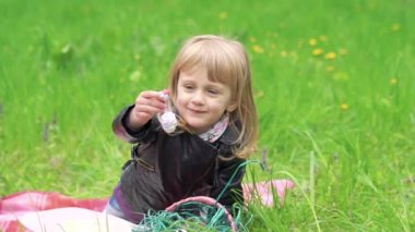 Küçük kız süslemeleri Paskalya için holding'ın bahçesinde. Yavaş yavaş