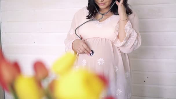 Pregnant woman being examine with stethoscope, on white background, 4k — Stock Video