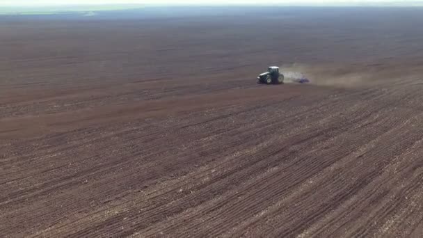 Aerial view of fertile soil, big fields, tractor plowing the soil — Stock Video