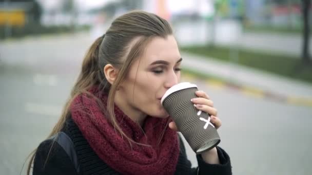 Beautiful girl drinks coffee at a gas station — Stock Video