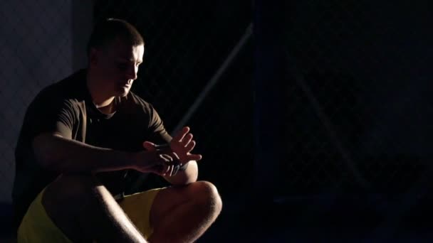 Maître sportif enveloppant des bandages sur sa main dans la salle de gym. Doucement. — Video