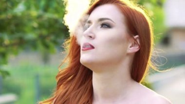 Kadın yüzünü, exhales duman açık kapatın. Ağır çekim