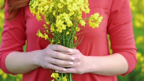 Bella ragazza con bouquet di stupro sul retro del campo. Rallentatore — Video Stock