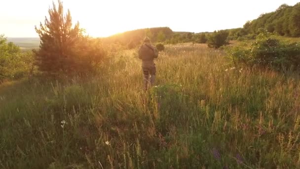 Vista aérea: Soldado em uniforme com autômato na natureza mãos para cima — Vídeo de Stock